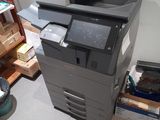 a black and white printer sitting on top of a stack of boxes