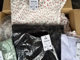 a box full of clothing that is sitting on the floor