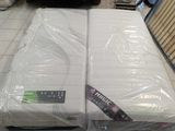 two mattresses sitting on top of each other in a store