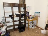 a room with a bookcase and a desk in it