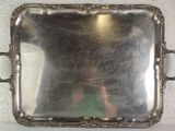 a silver tray with handles on a white table