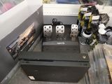 two video game controllers sitting on top of a black box