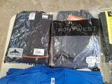 a lot of t - shirts that are on a table