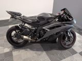 a black motorcycle that is parked on a checkered floor