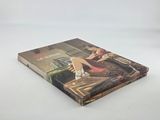 a book with a picture of a woman sitting on a chair