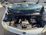 a car with its hood open on the street