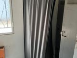 a picture of a kitchen with a refrigerator and a table