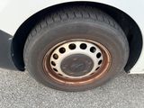 a close up of a flat tire on a white car