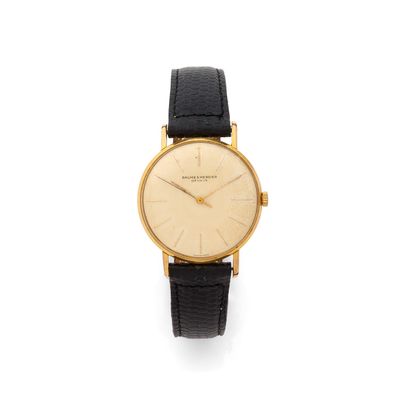 an 18k yellow gold wrist watch with black leather strap