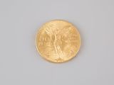 an image of a close up of a gold coin on a white surface