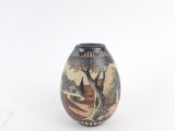 a small vase with a painting on it on a white surface