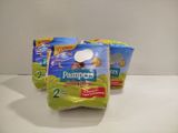 three packs of diapers sitting on top of a white counter
