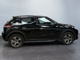 the black suv is parked in a large room with a gray floor