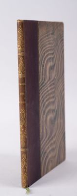 an old book sitting on top of a white surface
