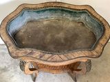a wooden table with a metal tray on it