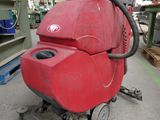 a red machine that is sitting on the floor