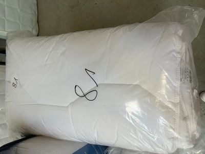 a pillow that has been wrapped in plastic on a bed