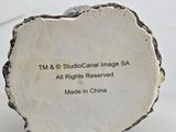 a close up of a rock with a tag on it sitting on a table