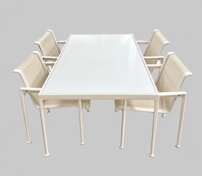 a white table with six chairs around it