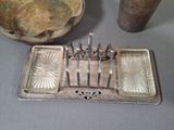 a silver tray with silverware on a table next to a bowl of chips