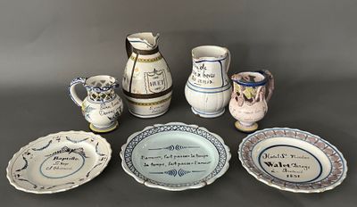 many different types of pottery on display on the table