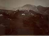 an old black and white photo of a castle on top of a hill