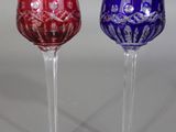 three wine glasses are sitting side by side on a table