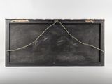 an old black box with a string wrapped around it on a white surface