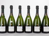 six bottles of wine are lined up in a row