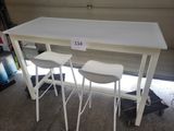 two white stools sitting at a table in a garage