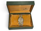 a watch in a box on a white surface