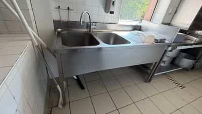 a kitchen with a stainless steel sink and a large window