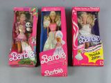 three barbie dolls are sitting in their boxes on a table