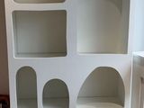 a white bookcase that has a lot of shelves on it