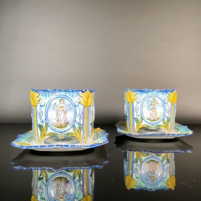two cups and saucers sitting on a table