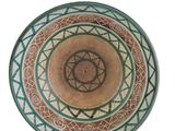 a green and brown bowl with a star of david on it