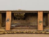 a small wooden box with a clock inside of it