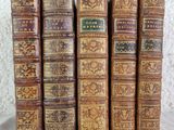 a group of old books sitting on top of a table