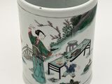 a white cup with a picture of a man and a woman in a garden