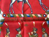 a red tie with a picture of a horse and soldiers on it