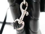 a black purse with a metal hook attached to it