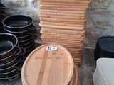 a stack of wooden plates and bowls sitting on a table