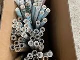 many rolls of paper in a cardboard box on the floor