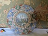 a plate with a picture on it sitting on a pillow