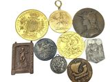 a lot of coins that are on a white surface