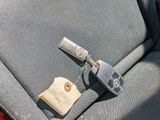 a car seat with a key and a tag attached to it