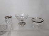a glass table with a glass bowl and a silver plate on it