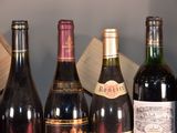 bottles of wine are lined up on a shelf in a wine cellar