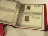 a red binder with stamps inside of it on a table
