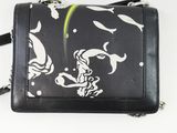 a black and white purse with a fish design on it